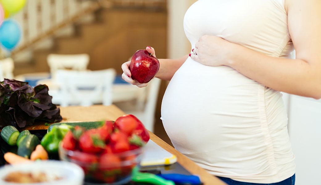 pregnant woman with fruit and vegetables