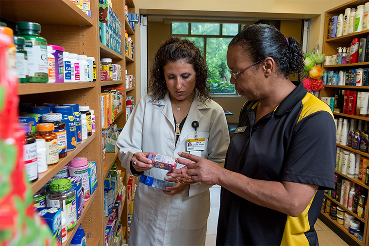 Photo of pharmacist helping patient.