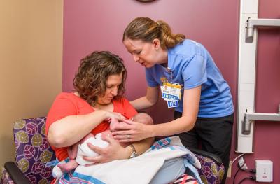 Lactation consultant with mom and newborn baby