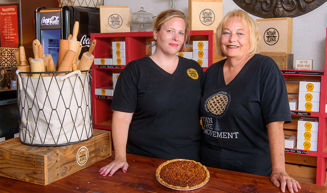 Photo of Rebecca Miller and Jeann Plumley baking pies.