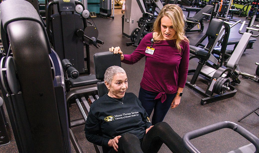 Brenda Hanson works out under the supervision of Katie Williamson