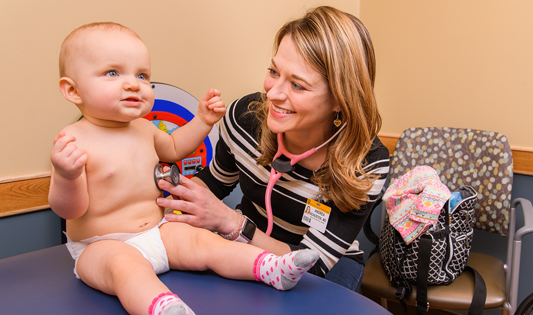 Andrea Schuster, MD with infant patient