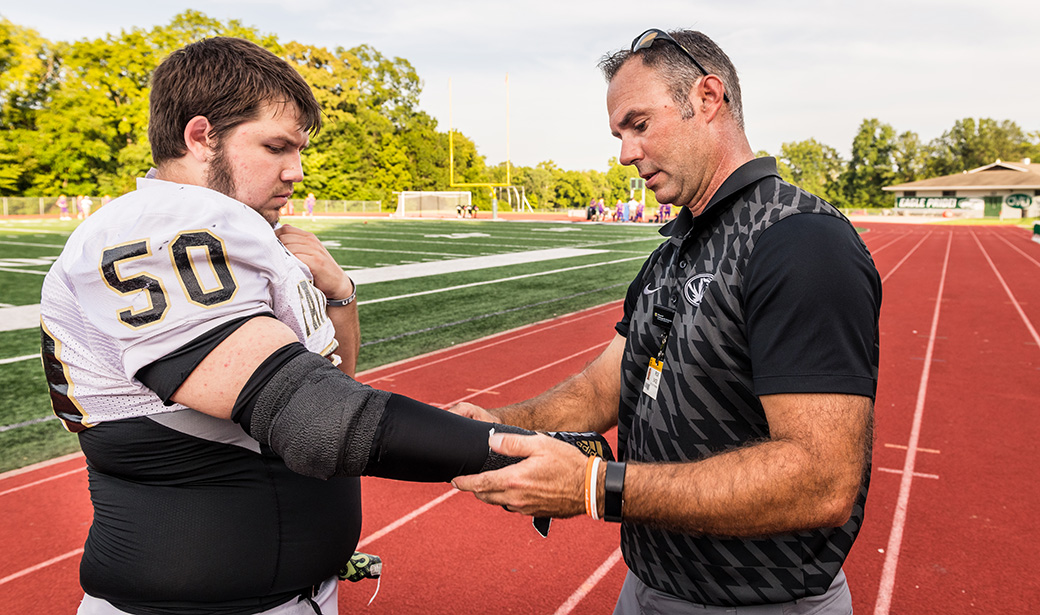 MU Health Care athletic trainer Rick Sage examines Zane Rice