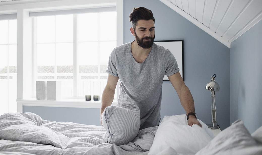 man making the bed