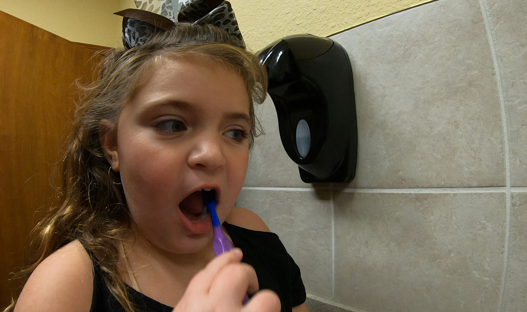 Reese White brushing her teeth