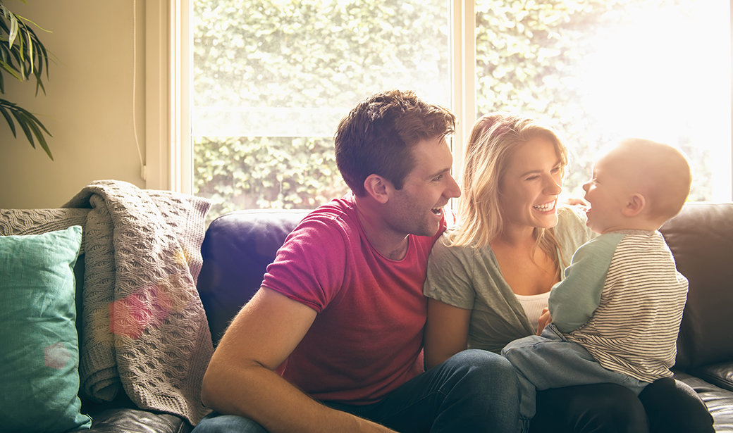 Photo of young family on a couch