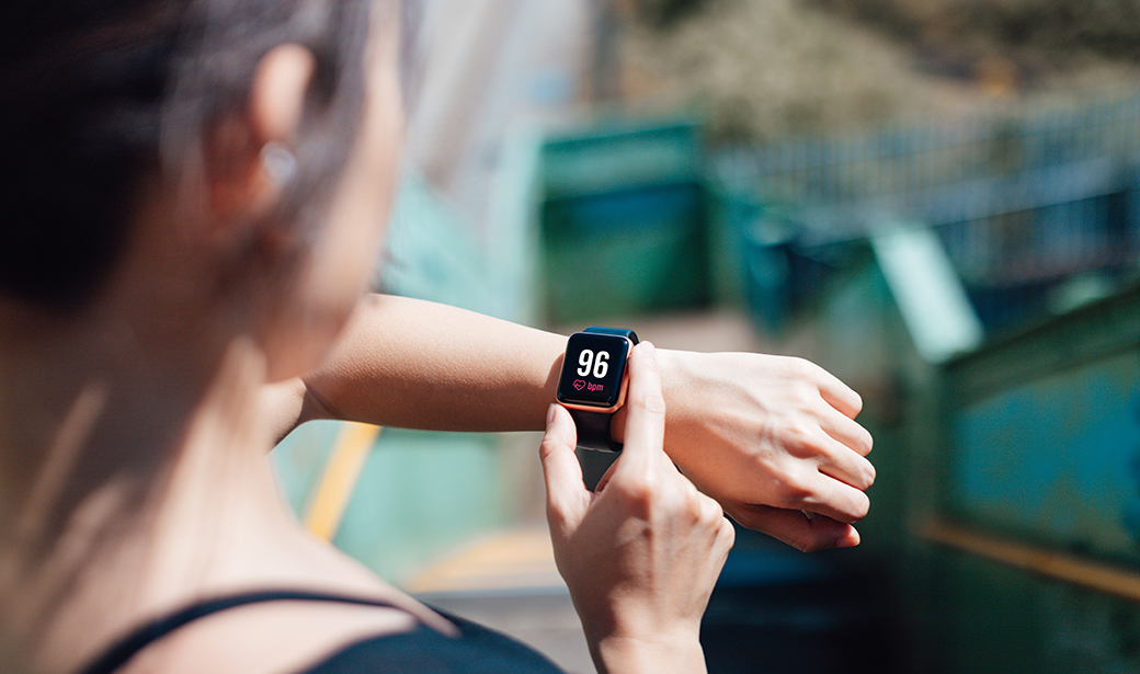 woman checking a wrist heart rate monitor