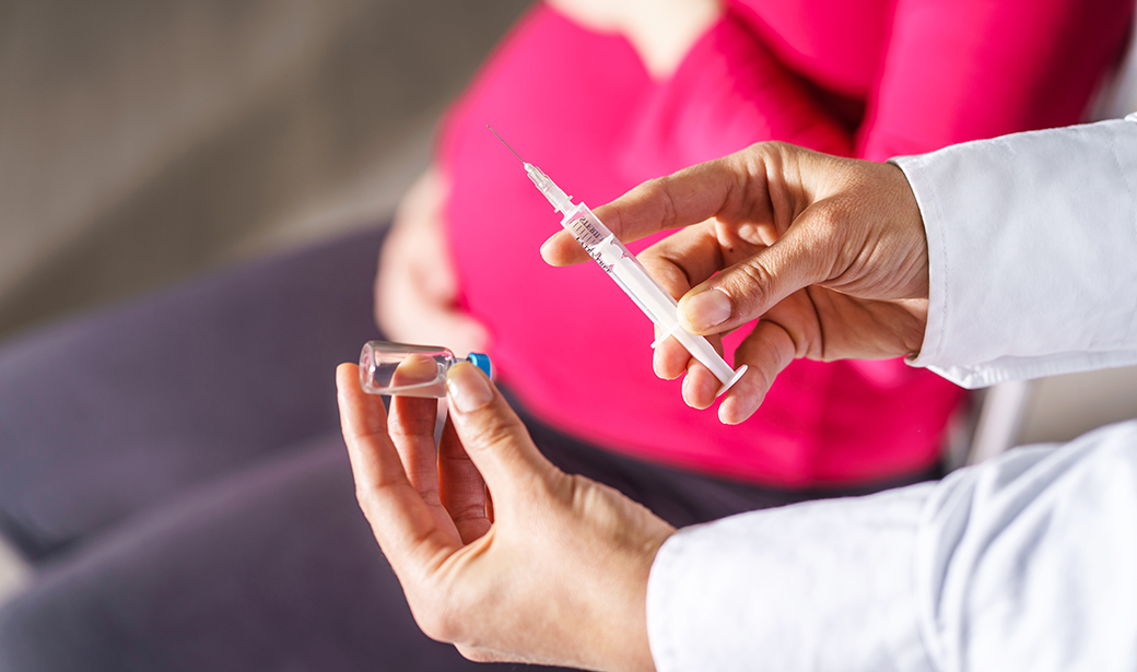 pregnant woman and doctor with a syringe