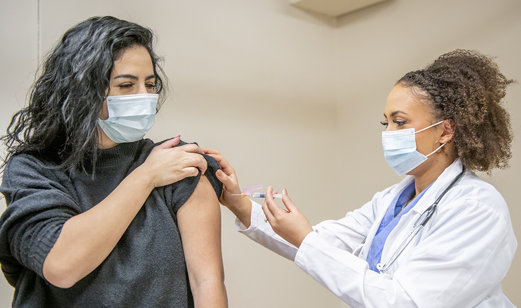 woman getting injection in her arm