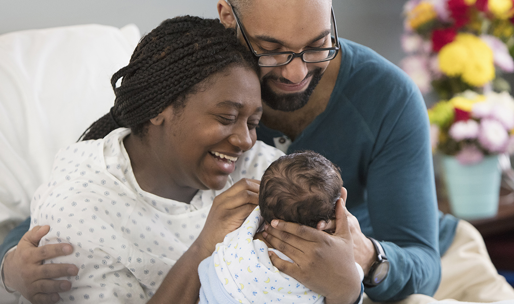 couple holding newborn