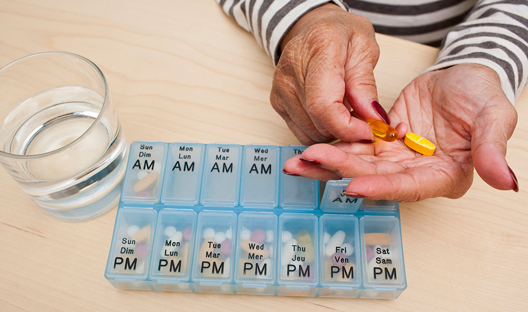 woman sorting medication pills