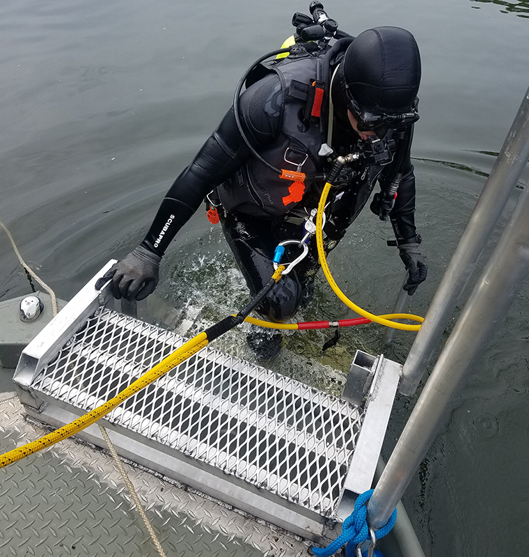 Kevin descends into the Osage river, using a surface-supplied air unit, to rehabilitate and monitor species of endangered Unionid mussels.