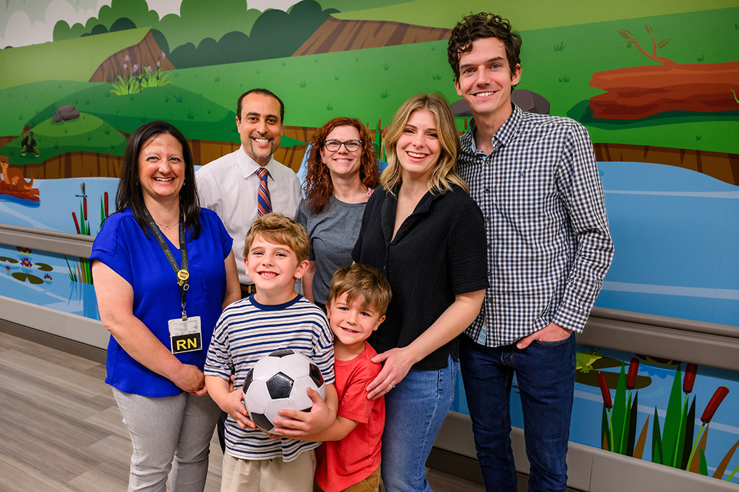 A family and healthcare professionals posing for a photo.