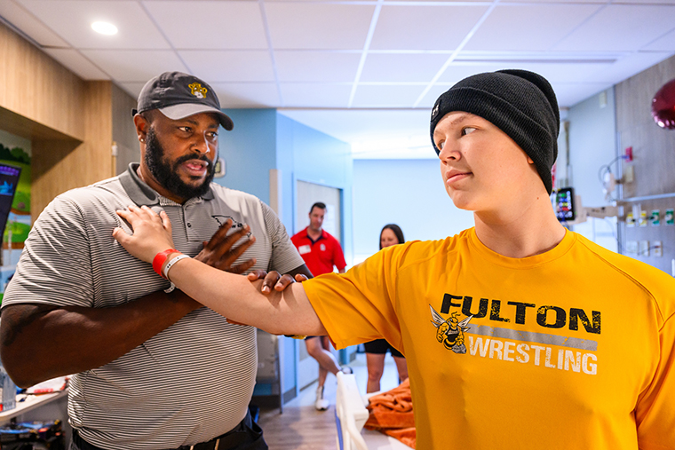 Parker and former Mizzou football player Attiyah Ellison simulate defensive line drills in Parker’s room at Children’s Hospital.