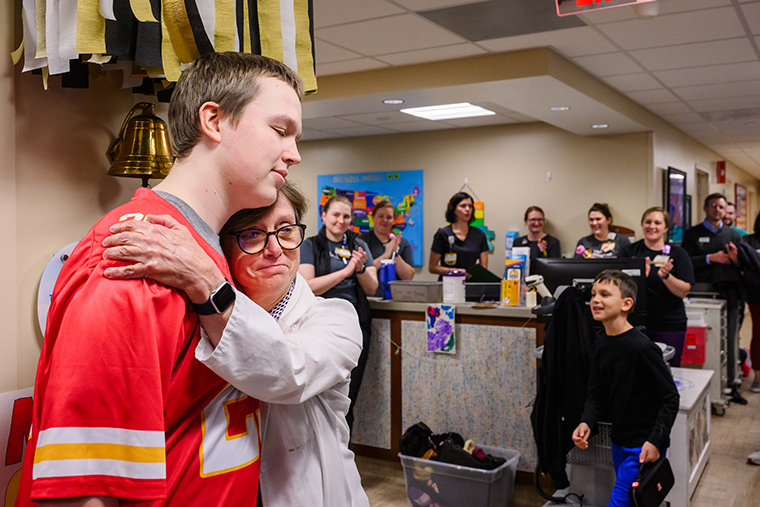 Parker receives a hug from Barbara Gruner, MD, at his bell-ringing ceremony to celebrate the end of chemotherapy treatment at Children’s Hospital on Jan. 14, 2025.