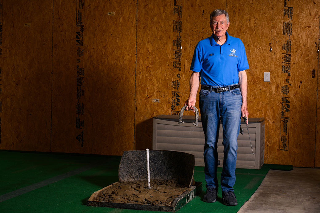 Mel holding a horshoe.