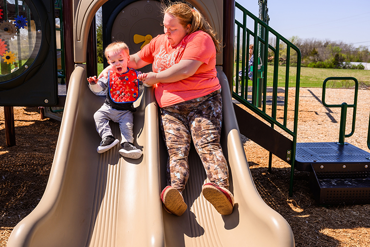 Matthew and Jessica slide together at a park near the family's home in Columbia.