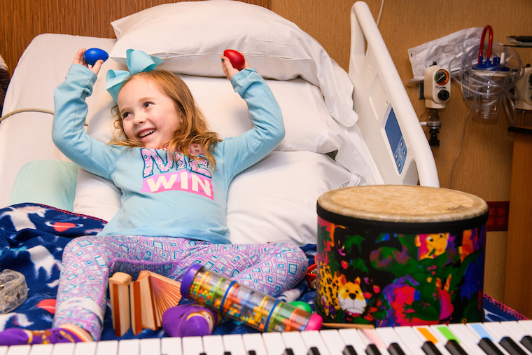 Photo of little girl playing music