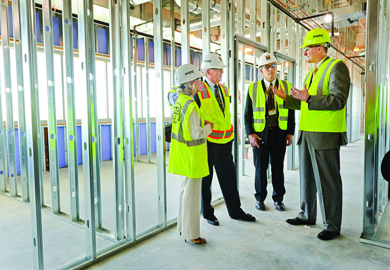 James Cook, DVM, PhD, explains plans while on a tour of the construction site for the Thompson Laboratory for Regenerative Orthopaedics at the Missouri Orthopaedic Institute. From left: Nancy Thompson, Bill Thompson, James Stannard, MD, and Cook.