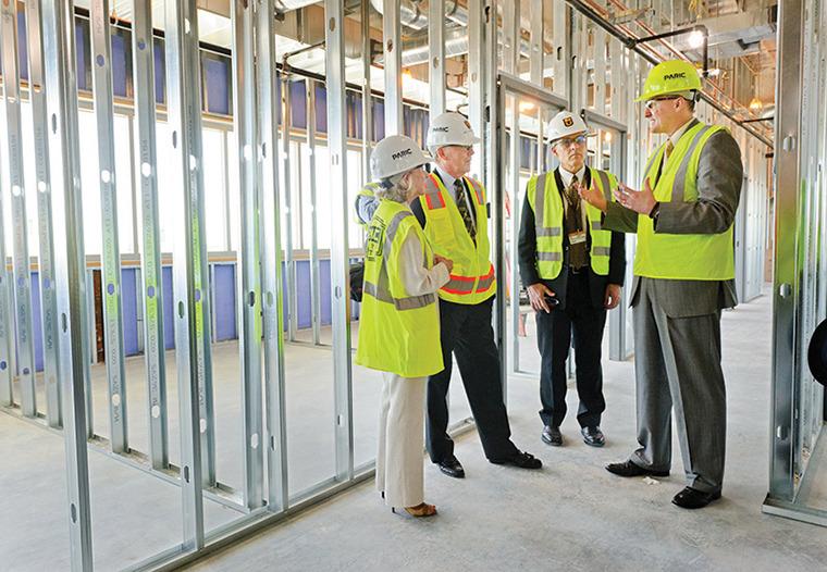 James Cook, DVM, PhD, explains plans while on a tour of the construction site for the Thompson Laboratory for Regenerative Orthopaedics at the Missouri Orthopaedic Institute. From left: Nancy Thompson, Bill Thompson, James Stannard, MD, and Cook.