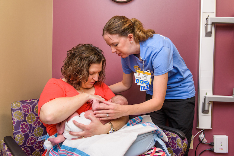 MU Health Care lactation consultant working with mom and newborn baby