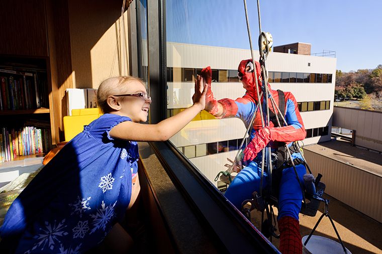 Superhero window washers at MU Children's Hospital