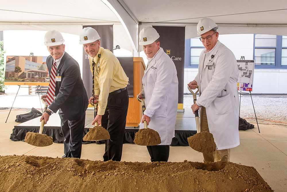 men shoveling dirt