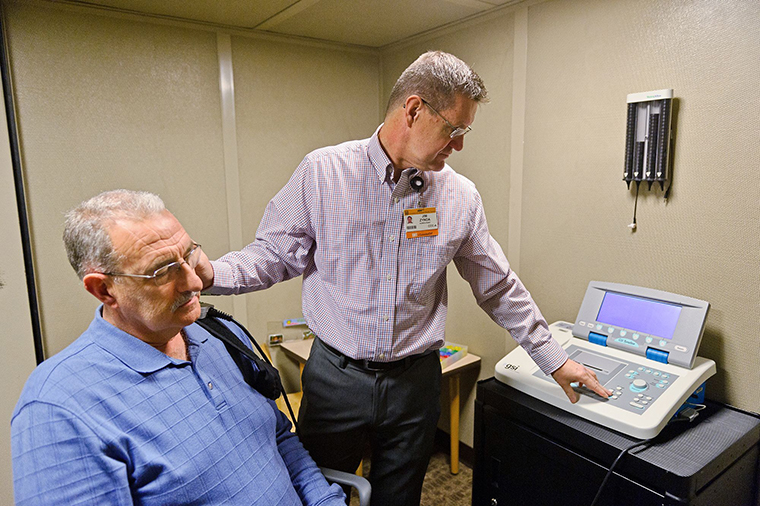 photo of man getting hearing loss test
