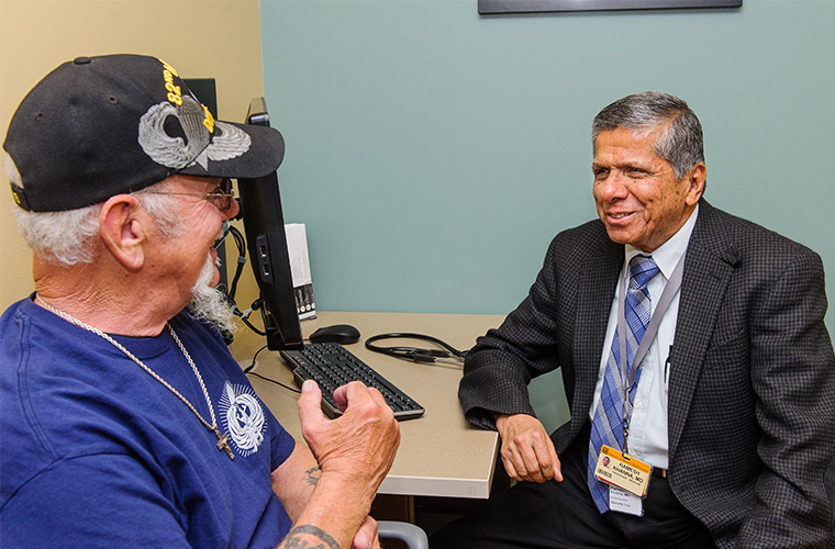 Photo of nephrology doctor visiting with a patient. 