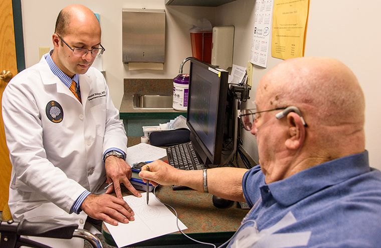 Photo of Dr. Siddiqui treating a patient