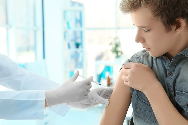Photo of teen boy getting a vaccine.