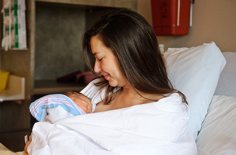 Photo of mom holding baby to chest.