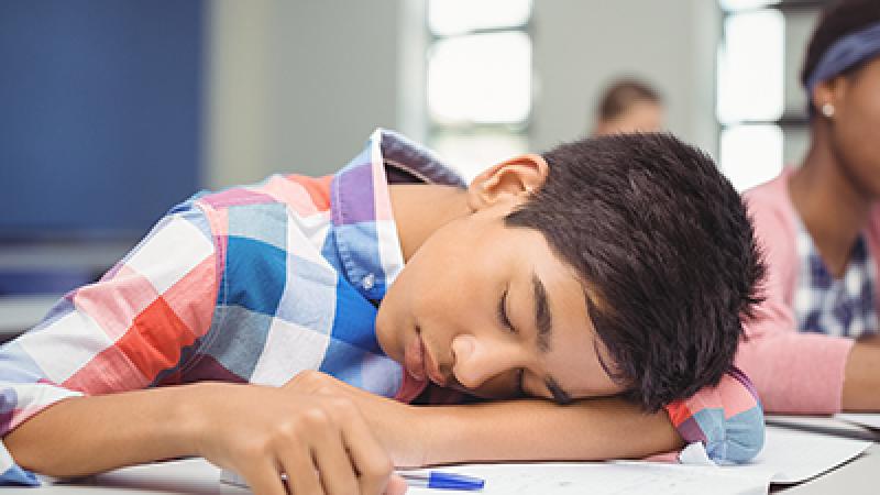 boy sleeping in class