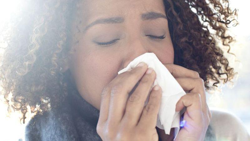 woman blowing nose