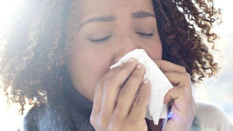 woman blowing nose