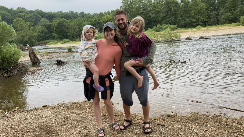 A picture of a family at a lake.