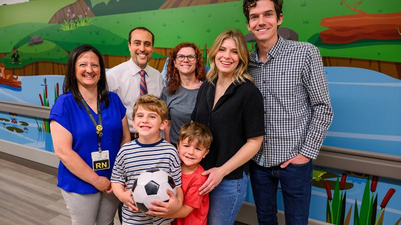 A family and healthcare professionals posing for a photo.