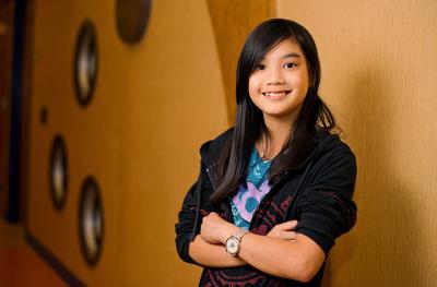 Young Girl leaning against wall