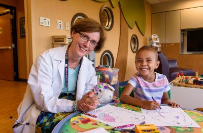 Young cancer patient with doctor in hospital