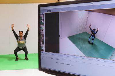 Man doing calesthenics while being recorded on computer