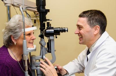 Frederick Fraunfelder, MD, MBA, performs an eye exam. 