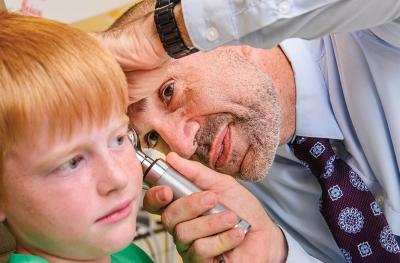 Gov-Ari examining child