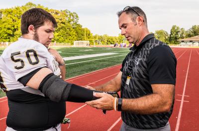 MU Health Care athletic trainer Rick Sage examines Zane Rice