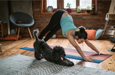 Woman working out at home with dog
