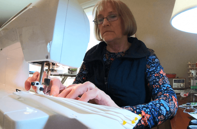 Photo of volunteer sewing masks