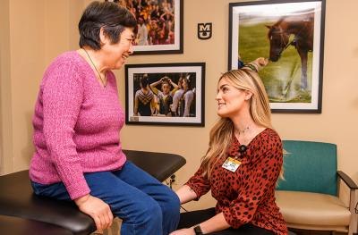Sarah Moore, DPT, helps Ling Ling Wang at the Mizzou Therapy Services clinic in Fulton.