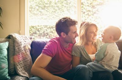 Photo of young family on a couch
