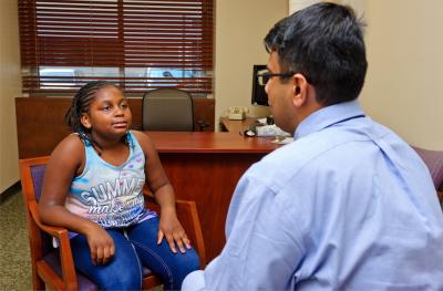Provider speaking with young female patient