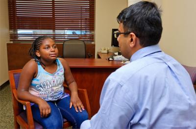 Provider speaking with young female patient