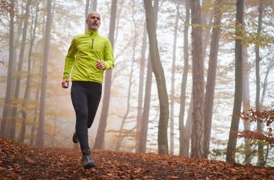 Photo of man running on wooded trail